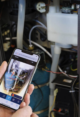 A coffee machine technician servicing a coffee machine