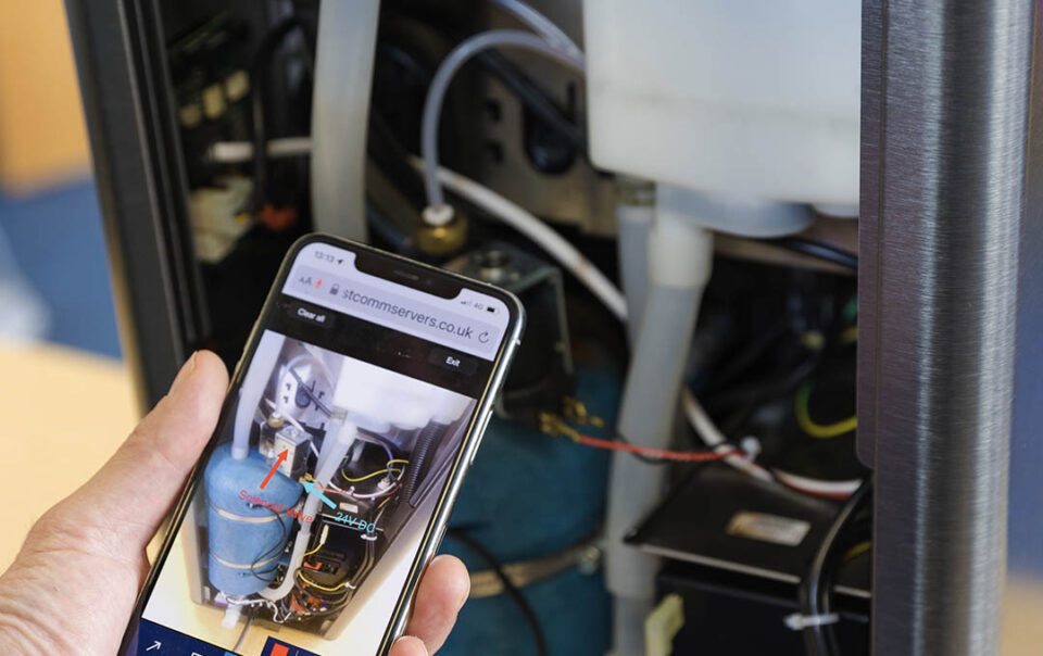 A coffee machine technician servicing a coffee machine